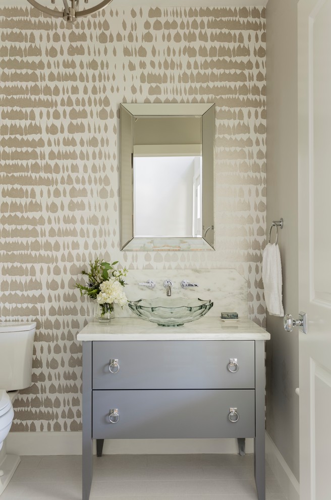 This is an example of a classic cloakroom in DC Metro with flat-panel cabinets, grey cabinets, a two-piece toilet, multi-coloured walls, painted wood flooring, a vessel sink and grey floors.