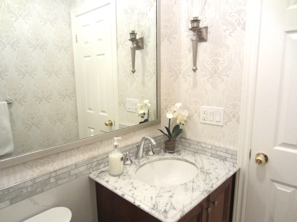 Example of a small classic white tile and porcelain tile powder room design in Toronto with furniture-like cabinets, dark wood cabinets, marble countertops and an undermount sink