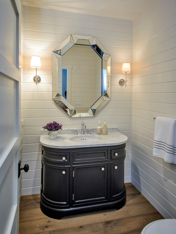 Transitional medium tone wood floor powder room photo in San Francisco with an undermount sink, black cabinets, white walls and white countertops