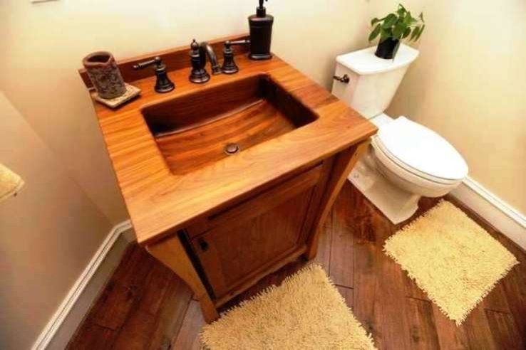Photo of a medium sized traditional cloakroom in Other with freestanding cabinets, medium wood cabinets, wooden worktops, a one-piece toilet, beige walls and medium hardwood flooring.