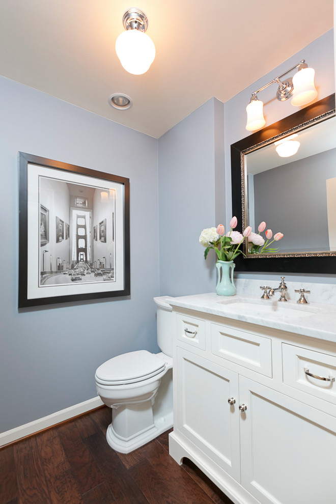 Idee per un bagno di servizio chic di medie dimensioni con ante in stile shaker, ante bianche, pareti blu, parquet scuro, lavabo sottopiano, top in marmo e top bianco