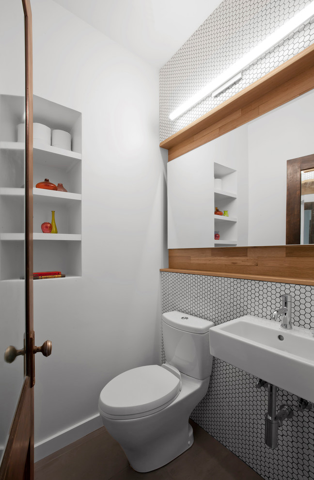 Powder room - mid-sized transitional white tile and mosaic tile porcelain tile and brown floor powder room idea in Indianapolis with a two-piece toilet, white walls and a wall-mount sink
