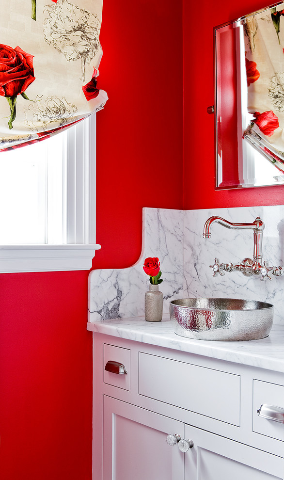 Powder room - mid-sized transitional powder room idea in Boston with shaker cabinets, white cabinets, red walls, a vessel sink, marble countertops and white countertops