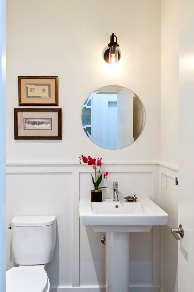 Small farmhouse cloakroom in Other with white walls, light hardwood flooring, grey floors, a two-piece toilet and a pedestal sink.