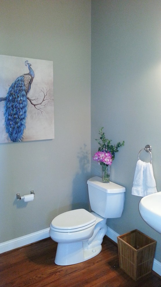 Inspiration for a small timeless medium tone wood floor powder room remodel in Philadelphia with a pedestal sink and gray walls