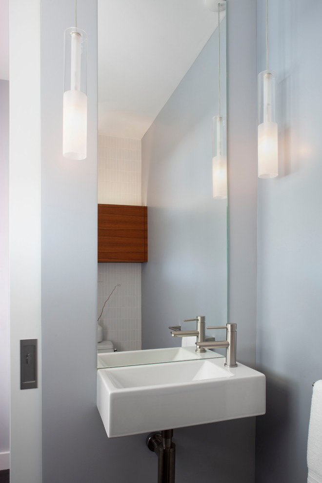 Inspiration for a small transitional white tile and ceramic tile porcelain tile and gray floor powder room remodel in San Francisco with flat-panel cabinets, medium tone wood cabinets, a one-piece toilet, gray walls and a wall-mount sink