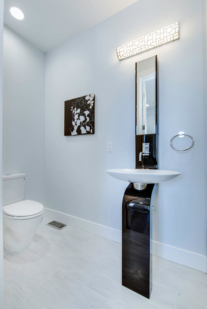 Klassisk inredning av ett toalett, med vita väggar och ett fristående handfat
