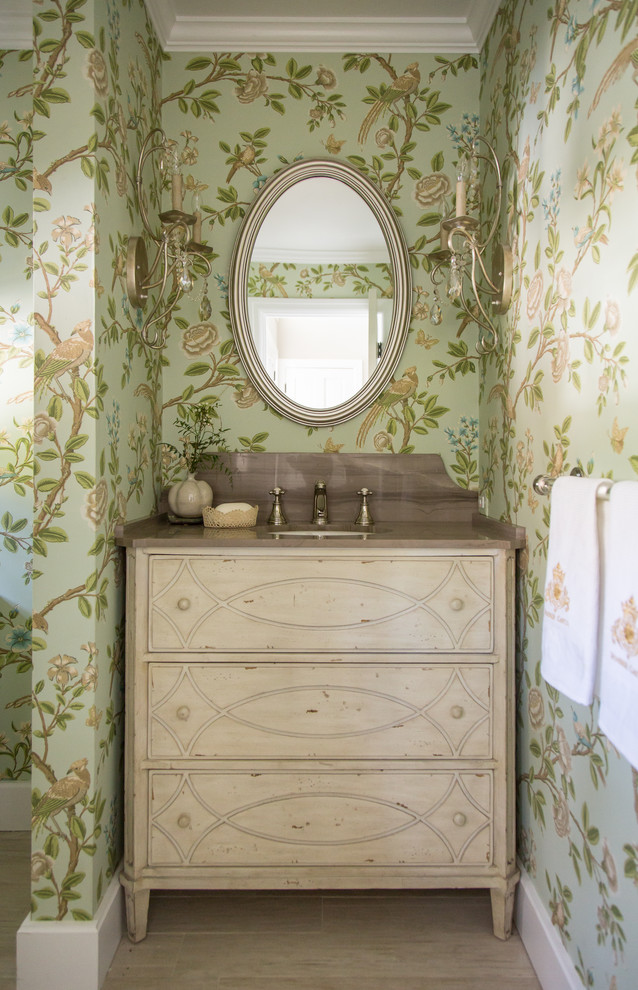 Powder room - shabby-chic style ceramic tile powder room idea in Los Angeles with an undermount sink, furniture-like cabinets, light wood cabinets, green walls, marble countertops and brown countertops