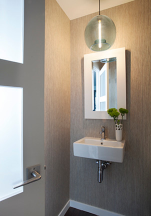 Mid-century modern dark wood floor powder room photo in Los Angeles with a wall-mount sink