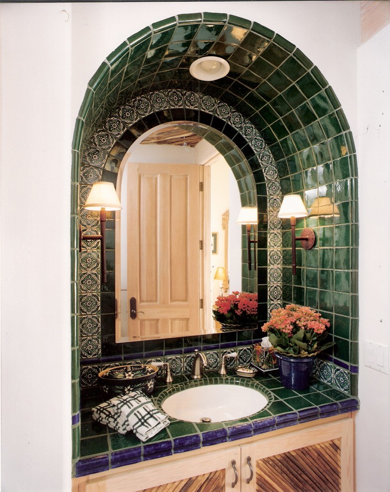 Design ideas for a medium sized mediterranean cloakroom in San Diego with light wood cabinets, tiled worktops, a two-piece toilet, a submerged sink, recessed-panel cabinets, green tiles and ceramic tiles.