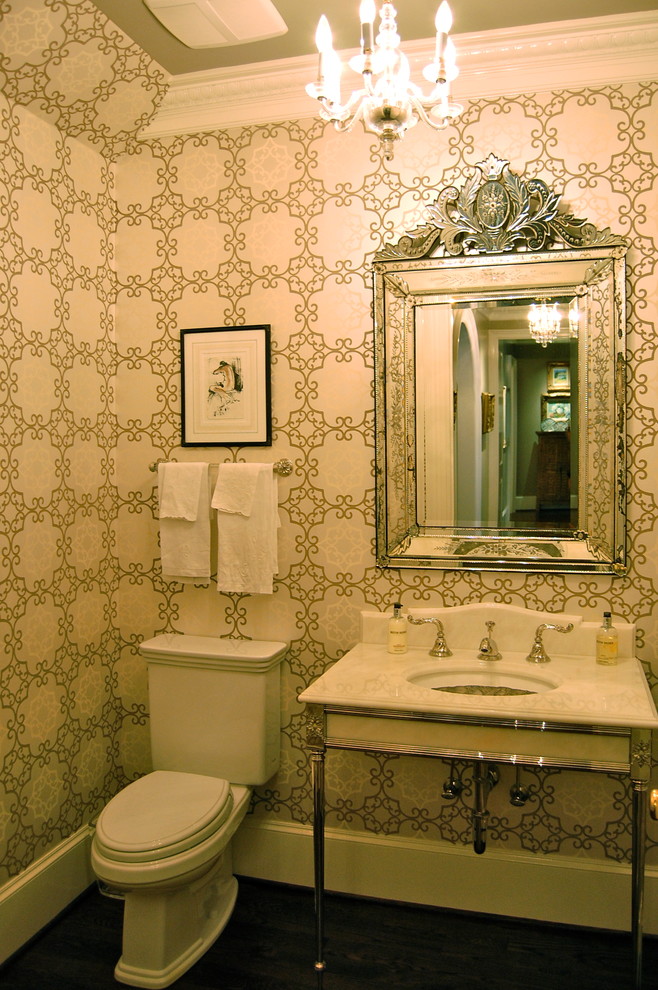 Photo of a classic cloakroom in Raleigh with a one-piece toilet, beige walls, dark hardwood flooring, a wall-mounted sink and marble worktops.