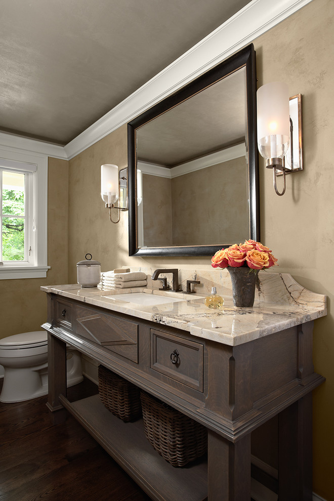 Elegant powder room photo in Minneapolis with an undermount sink, open cabinets, dark wood cabinets and beige countertops