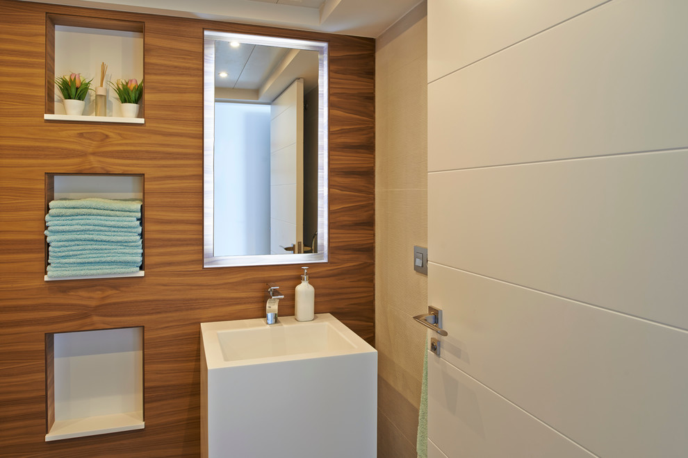 Design ideas for a small modern cloakroom in Alicante-Costa Blanca with an integrated sink, recessed-panel cabinets, a one-piece toilet, beige tiles, ceramic tiles, ceramic flooring, tiled worktops and beige floors.