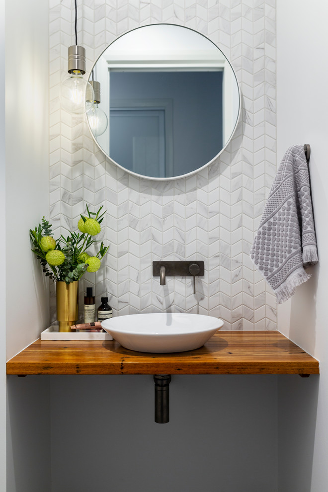 Design ideas for a contemporary cloakroom with porcelain tiles, porcelain flooring, wooden worktops, grey floors, grey tiles, white tiles, white walls, a vessel sink, brown worktops and medium wood cabinets.