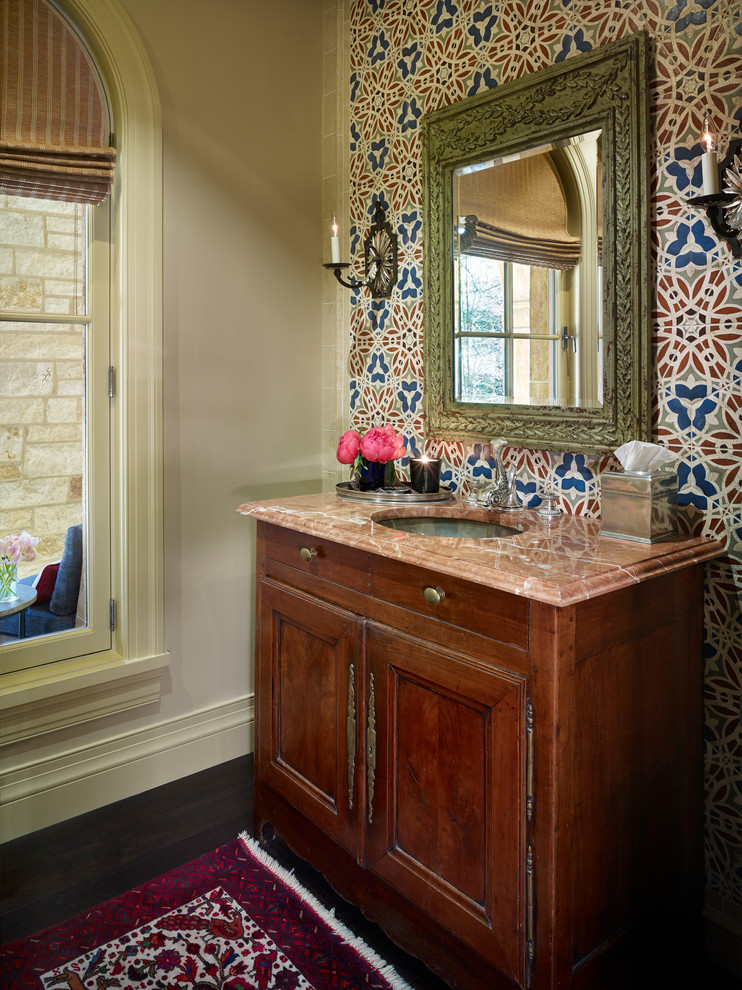 Idées déco pour un WC et toilettes méditerranéen en bois foncé avec un lavabo encastré, un placard avec porte à panneau encastré, un mur multicolore et parquet foncé.