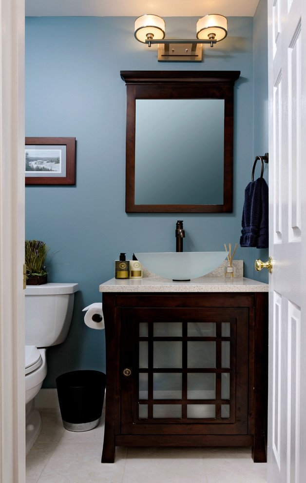 Example of a small classic powder room design in DC Metro with glass-front cabinets, dark wood cabinets, blue walls and a vessel sink