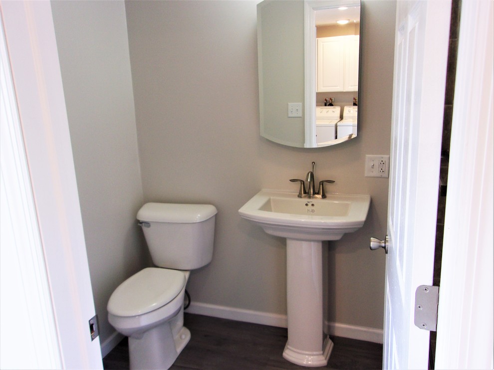 Photo of a small traditional cloakroom in Other with brown tiles, ceramic tiles, brown walls, vinyl flooring and grey floors.