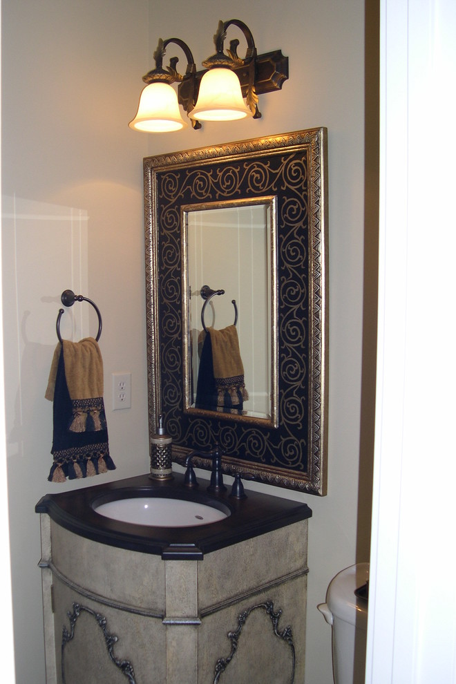 Design ideas for a large classic cloakroom in Charlotte with freestanding cabinets, distressed cabinets, a one-piece toilet, grey tiles, porcelain tiles, beige walls, a submerged sink and wooden worktops.