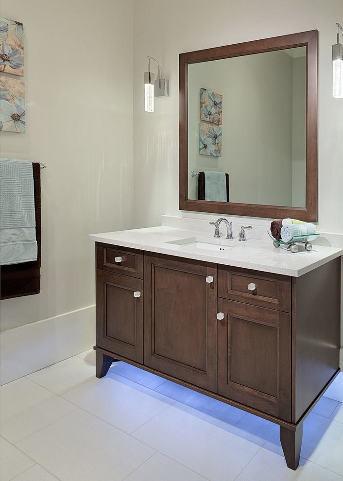 Example of a mountain style powder room design in Vancouver with an undermount sink, recessed-panel cabinets, medium tone wood cabinets and quartz countertops