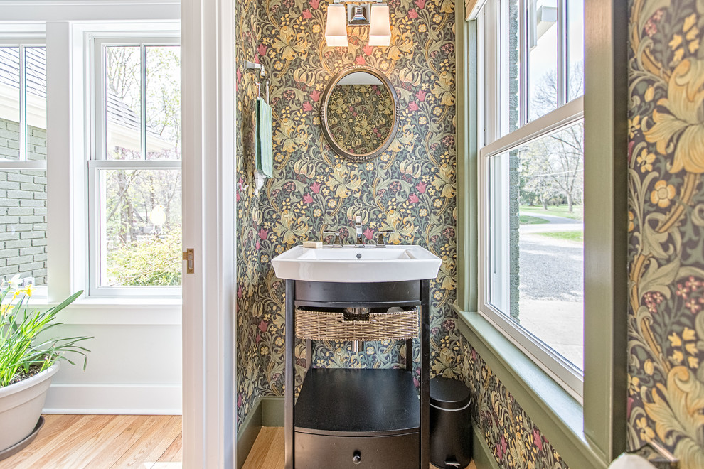 This is an example of a small classic cloakroom in Detroit with open cabinets, black cabinets and light hardwood flooring.