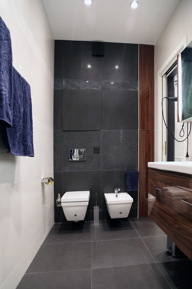 Medium sized contemporary cloakroom in Moscow with a wall-mounted sink, medium wood cabinets, a wall mounted toilet, grey tiles, beige walls, ceramic flooring and ceramic tiles.