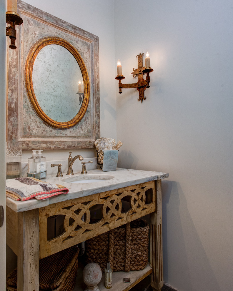 Design ideas for a medium sized classic cloakroom in Little Rock with open cabinets, distressed cabinets, white walls, a submerged sink, marble worktops, brown floors and beige worktops.