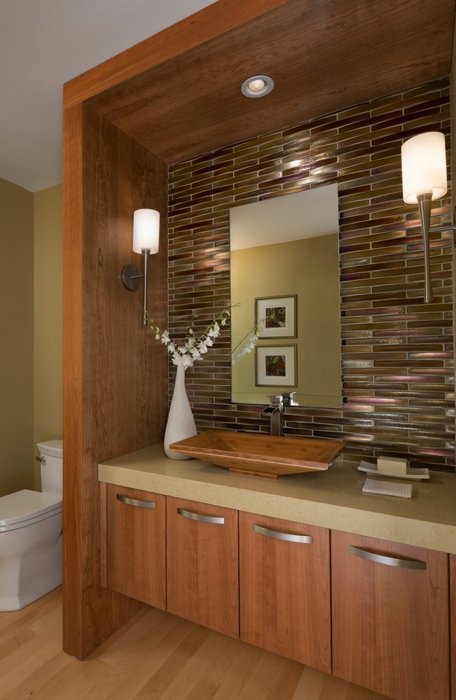 Powder room - mid-sized contemporary glass tile light wood floor powder room idea in Detroit with a vessel sink, flat-panel cabinets, medium tone wood cabinets, brown walls, quartz countertops and brown countertops