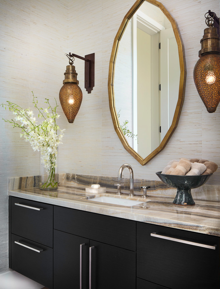 Powder room - contemporary powder room idea in Denver with black cabinets, an undermount sink, onyx countertops, flat-panel cabinets and beige walls