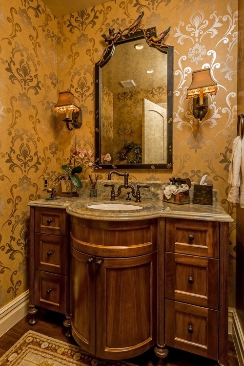 Idée de décoration pour un petit WC et toilettes tradition en bois brun avec un placard avec porte à panneau encastré, un lavabo encastré, un plan de toilette en marbre, WC à poser, un mur beige, parquet foncé et un sol marron.
