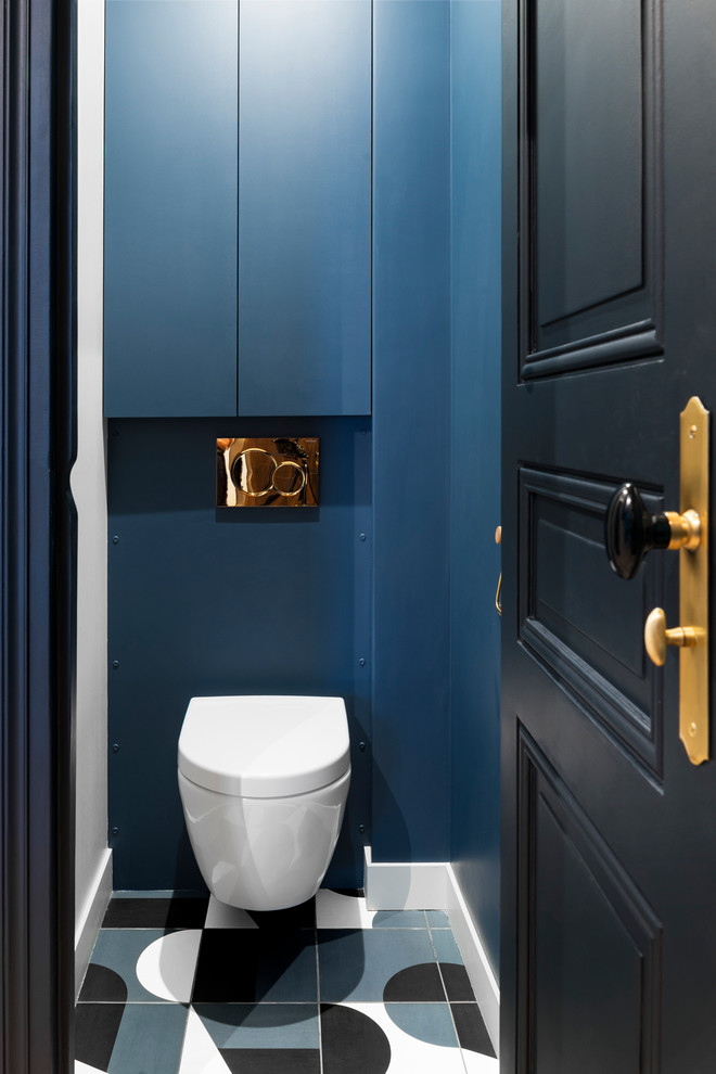 Photo of a small contemporary cloakroom in Other with blue walls, blue tiles, multi-coloured floors, a wall mounted toilet and cement flooring.