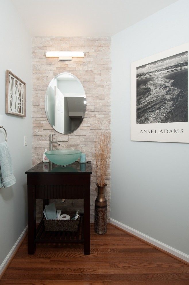 Powder room - mid-sized contemporary medium tone wood floor powder room idea in Philadelphia with a vessel sink and open cabinets