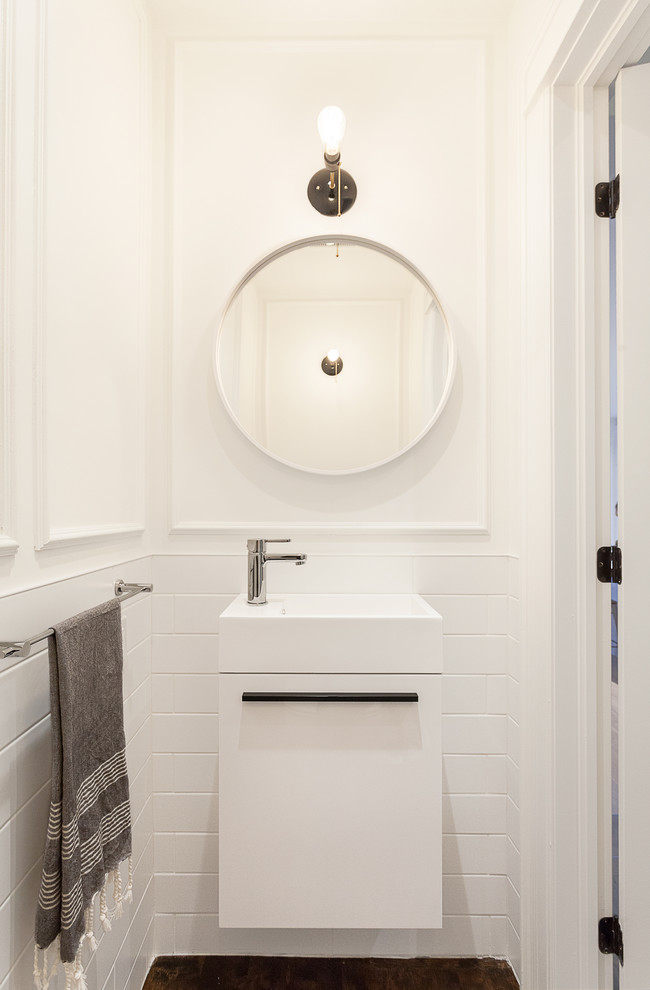 Small contemporary cloakroom in Ottawa with an integrated sink, flat-panel cabinets, white cabinets, white tiles, metro tiles, white walls, dark hardwood flooring and brown floors.