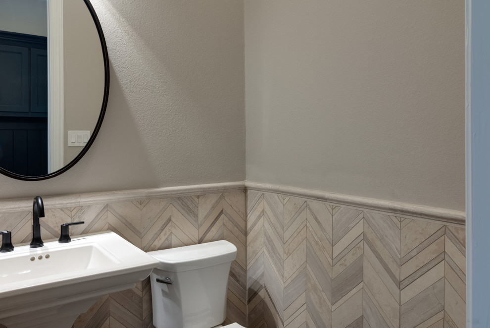 Inspiration for a small classic cloakroom in Dallas with a two-piece toilet, beige tiles, limestone tiles, beige walls, medium hardwood flooring, a pedestal sink and brown floors.