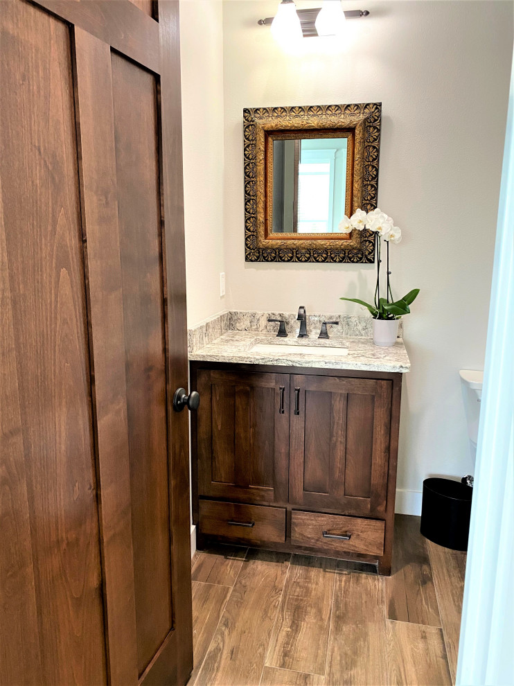 Powder room - mid-sized craftsman porcelain tile and multicolored floor powder room idea in Other with shaker cabinets, medium tone wood cabinets, gray walls, an undermount sink, granite countertops, multicolored countertops and a built-in vanity