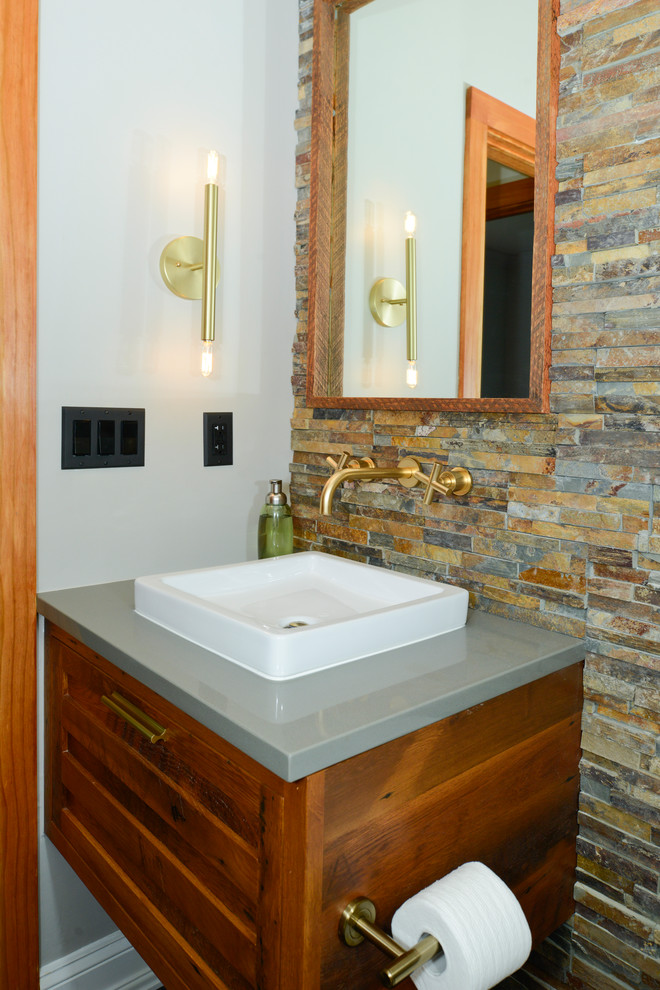 Mid-sized eclectic multicolored tile and stone tile porcelain tile and gray floor powder room photo in DC Metro with louvered cabinets, medium tone wood cabinets, a one-piece toilet, gray walls, a vessel sink and quartz countertops