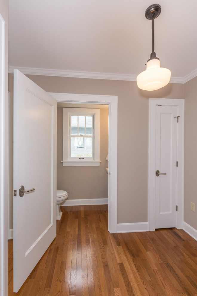 Small classic cloakroom in Columbus with a pedestal sink, beige walls and medium hardwood flooring.