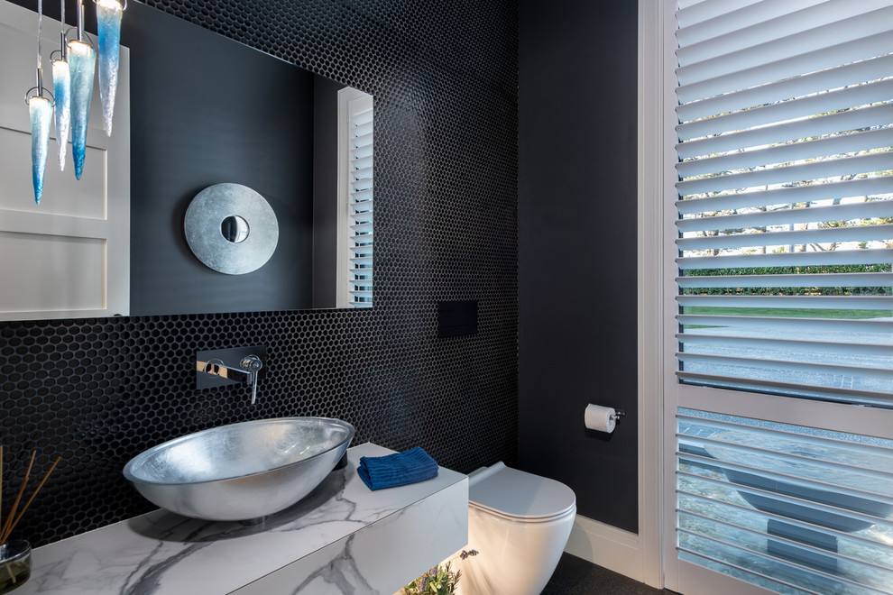 Large contemporary cloakroom in Auckland with flat-panel cabinets, grey cabinets, a one-piece toilet, black tiles, black walls, a vessel sink, tiled worktops, grey floors and multi-coloured worktops.