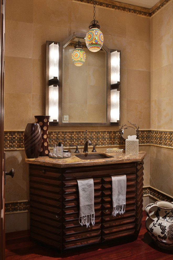Photo of a medium sized bohemian cloakroom in Miami with freestanding cabinets, dark wood cabinets, black walls, medium hardwood flooring, a submerged sink, granite worktops and red floors.