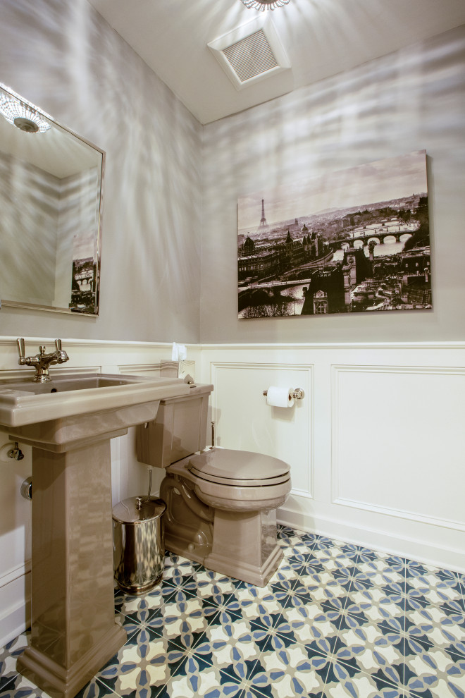 This is an example of a small traditional cloakroom in Columbus with beige cabinets, a two-piece toilet, white tiles, beige walls, cement flooring, a pedestal sink, blue floors, a freestanding vanity unit and wainscoting.