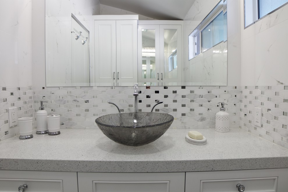 Powder room - small transitional gray tile, white tile and mosaic tile powder room idea in Orange County with beaded inset cabinets, white cabinets, a two-piece toilet, white walls, a vessel sink and quartz countertops