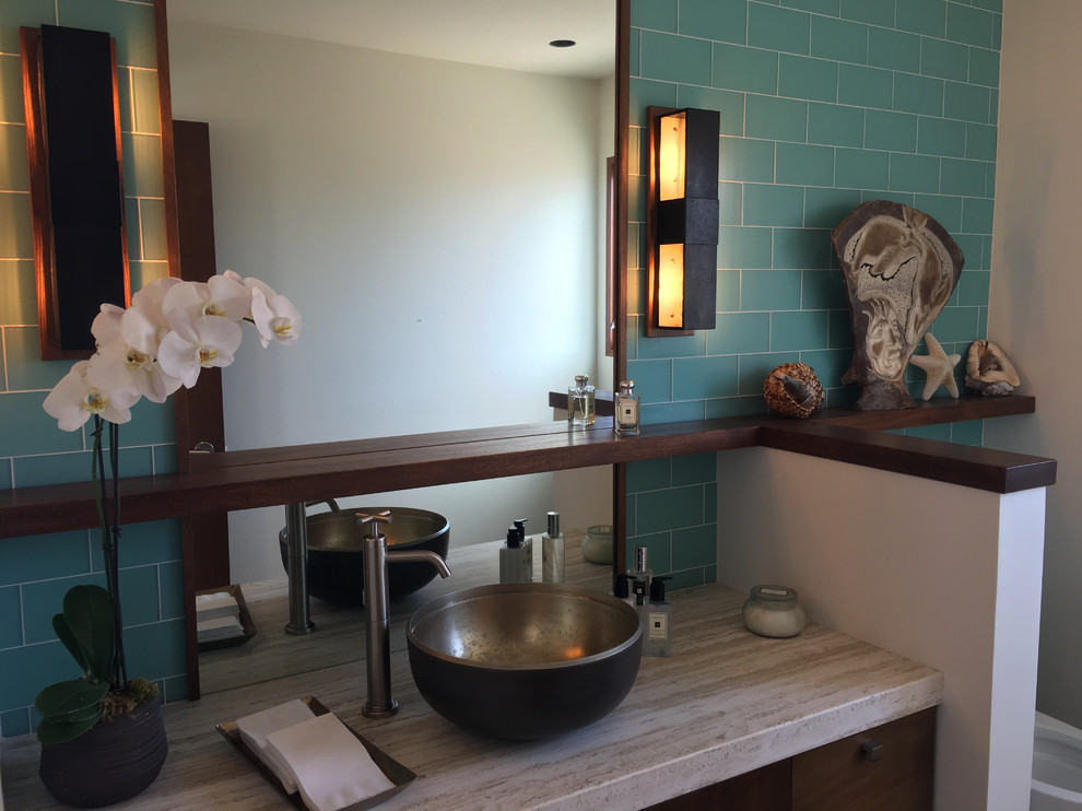 Photo of a small world-inspired cloakroom in Orange County with dark wood cabinets, grey walls, a vessel sink and wooden worktops.