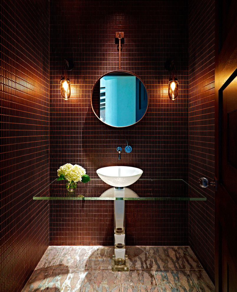 Inspiration for a contemporary cloakroom in Phoenix with a vessel sink, glass worktops, brown tiles and brown walls.