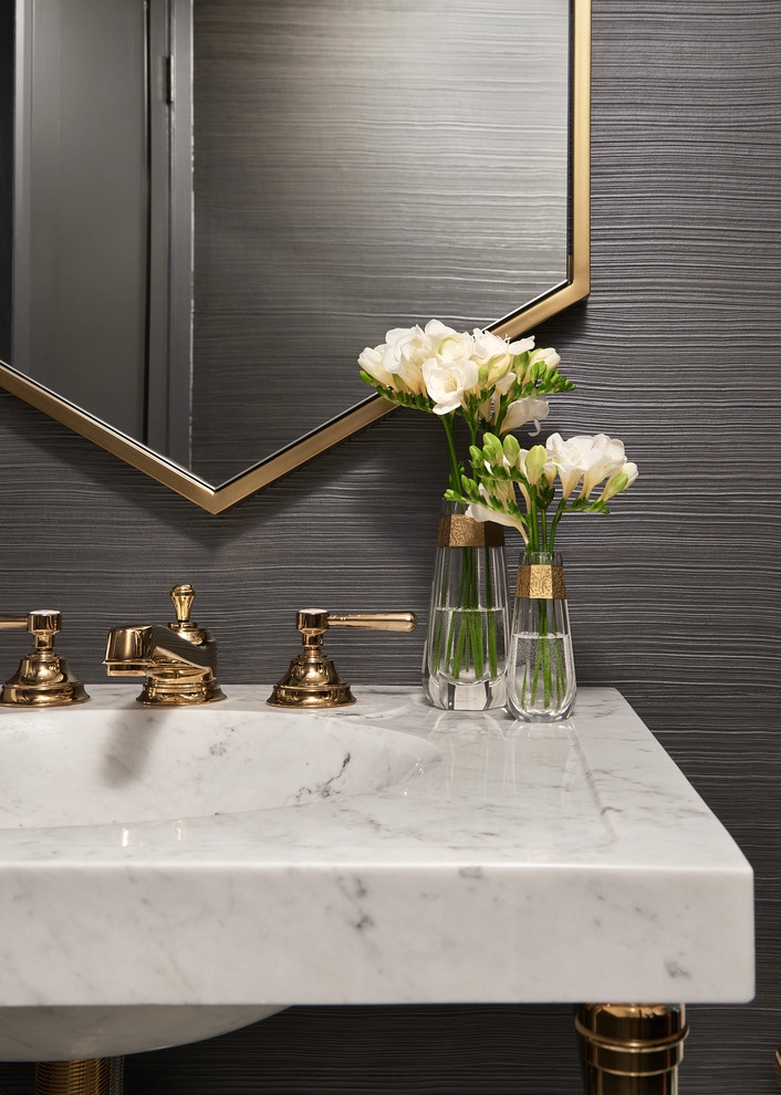 Mid-sized trendy porcelain tile and white floor powder room photo in Toronto with a one-piece toilet, gray walls, an integrated sink, marble countertops and white countertops