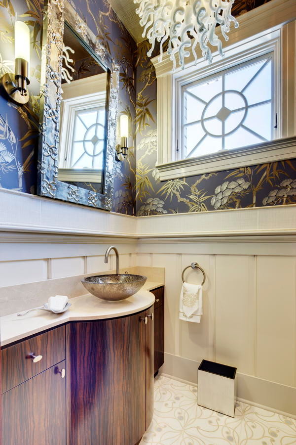 Powder room - small transitional marble floor and beige floor powder room idea in New York with flat-panel cabinets, dark wood cabinets, multicolored walls, a vessel sink and limestone countertops