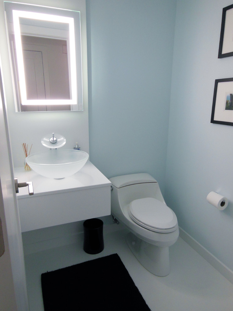 Inspiration for a small contemporary powder room remodel in Cincinnati with flat-panel cabinets, white cabinets, a one-piece toilet, blue walls and a vessel sink