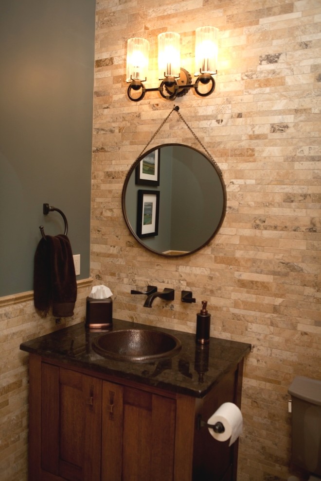 Photo of a medium sized rustic cloakroom in Calgary with recessed-panel cabinets, dark wood cabinets, beige tiles, travertine tiles, green walls, a built-in sink and granite worktops.