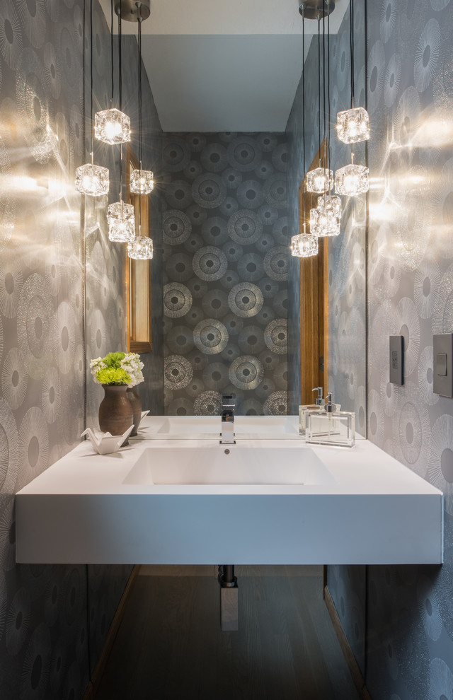 Ispirazione per un piccolo bagno di servizio minimal con pareti grigie, pavimento in vinile, lavabo sospeso, pavimento grigio, top in superficie solida e top bianco