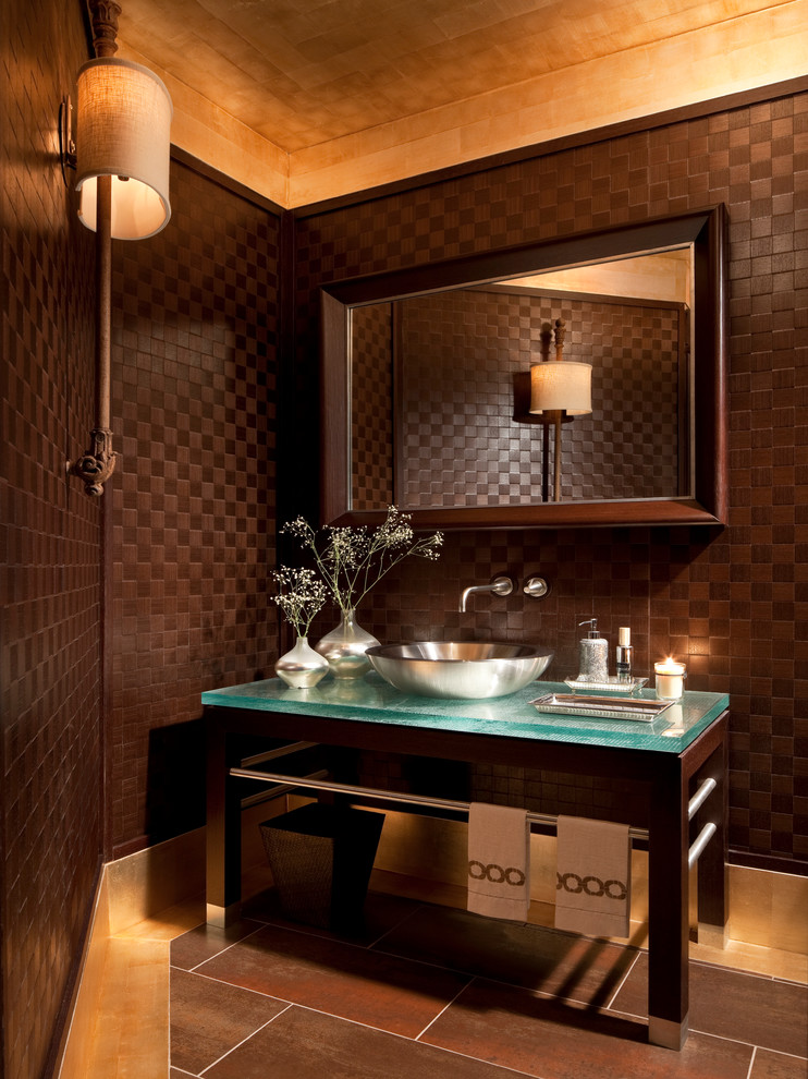 Powder room - contemporary powder room idea in New York with glass countertops