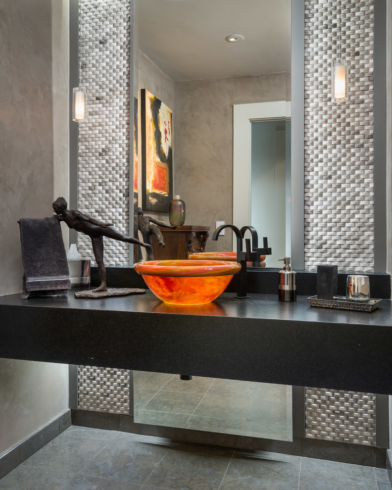 Example of a small trendy gray tile gray floor powder room design in Orange County with black countertops, gray walls and a vessel sink