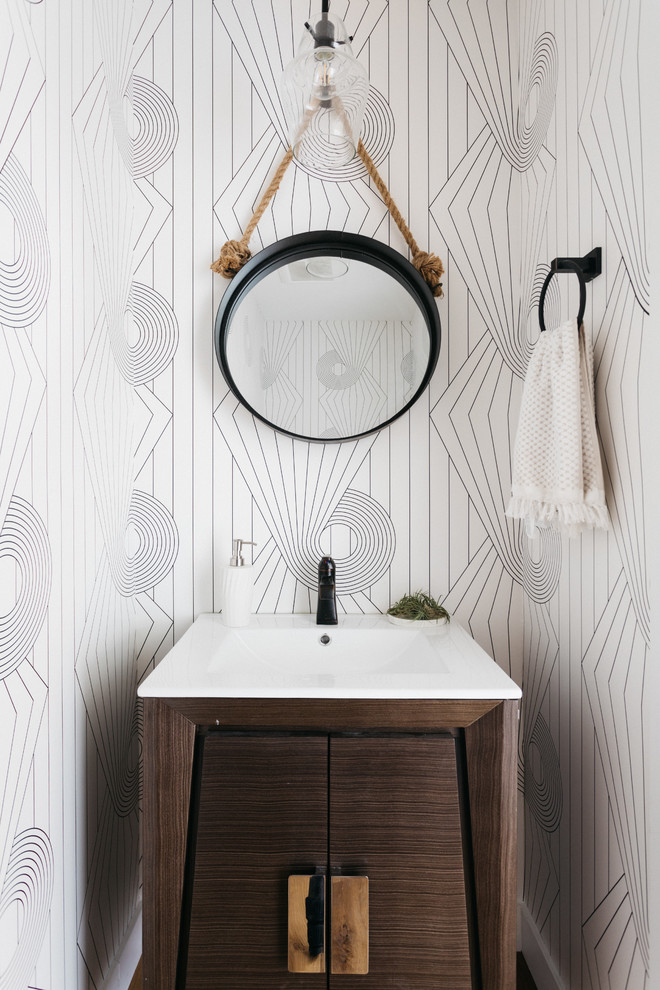 Inspiration for a small transitional light wood floor powder room remodel in Los Angeles with dark wood cabinets, white walls, an integrated sink, flat-panel cabinets and white countertops